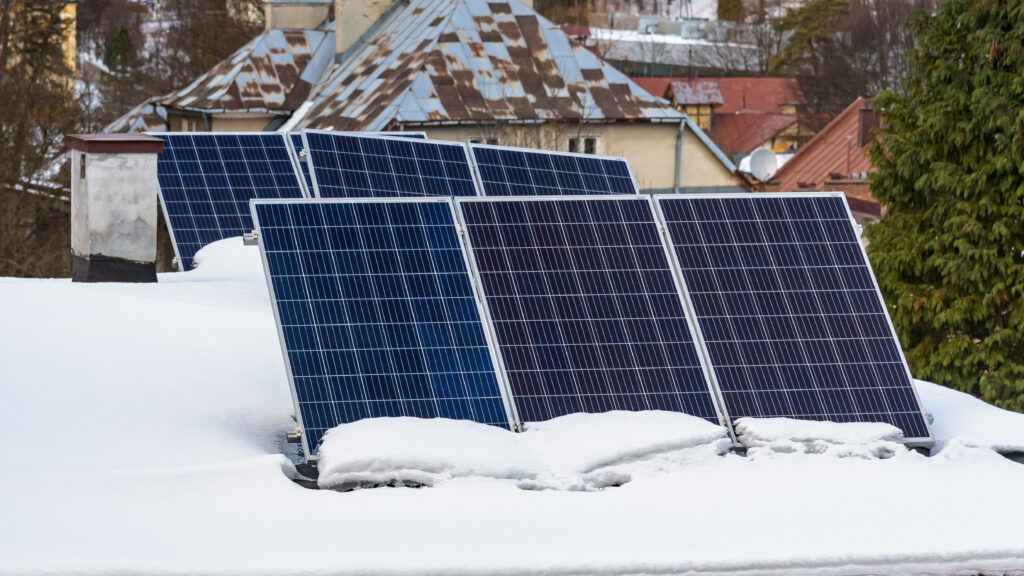 solar panels on the snow covered roof